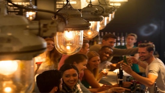 Crowded bar bathed in yellow light