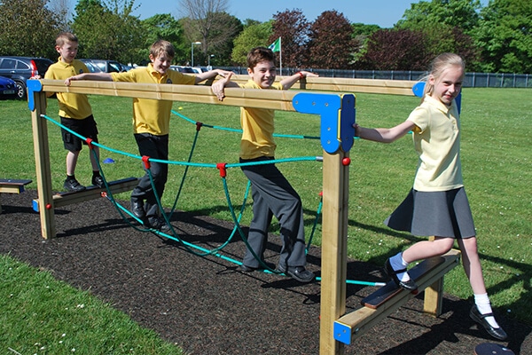 Children using a trim trail rope bridge