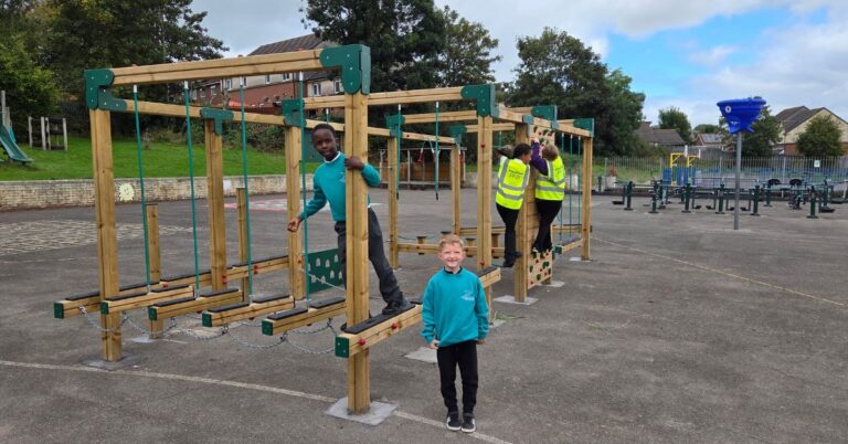 This image shows multiple children playing on a Spey Climbing frame